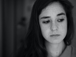 Young girl looking outwards with a sad face. Image: pablo-varela-vCfxXxbQRX8-unsplash